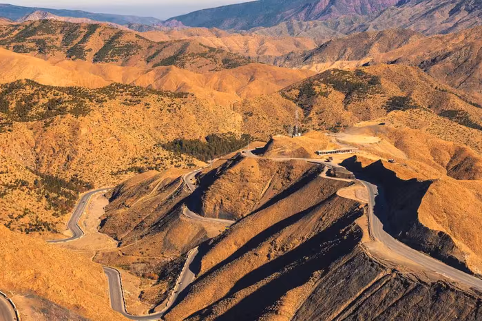 A mountain road climbing through the High Atlas range above Marrakech, Morocco