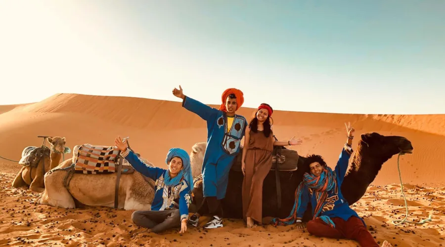 taking a picture in the desert with camels