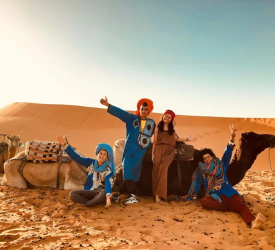 taking a picture in the desert with camels