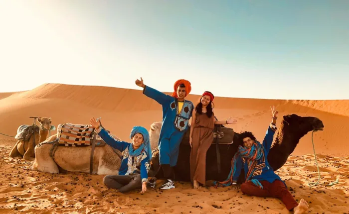 taking a picture in the desert with camels